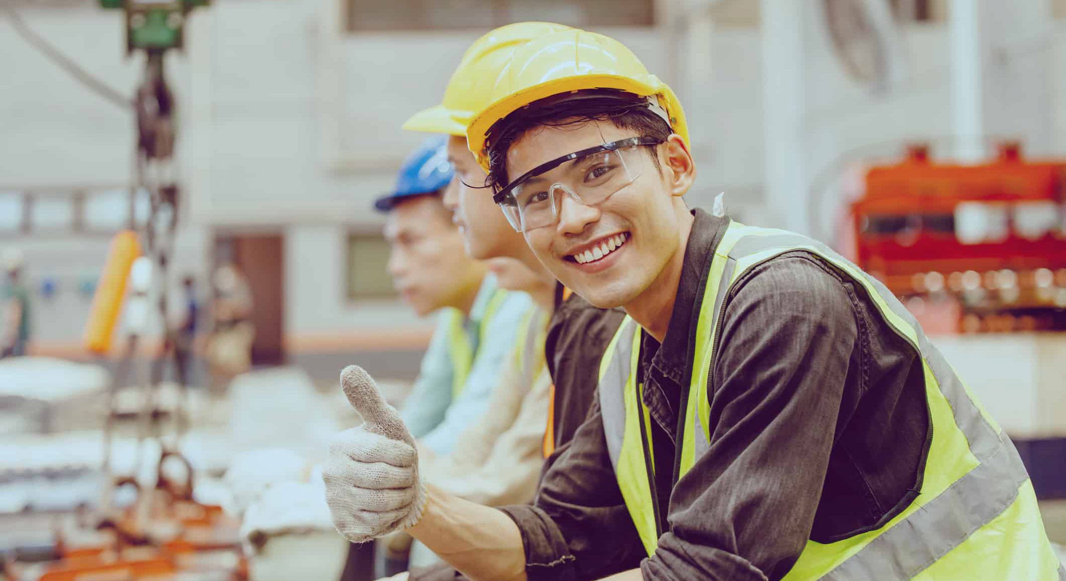 Chevron Phillips Intern Gives a Thumbs Up on the Jobsite Wearing Correct Safety Equipment