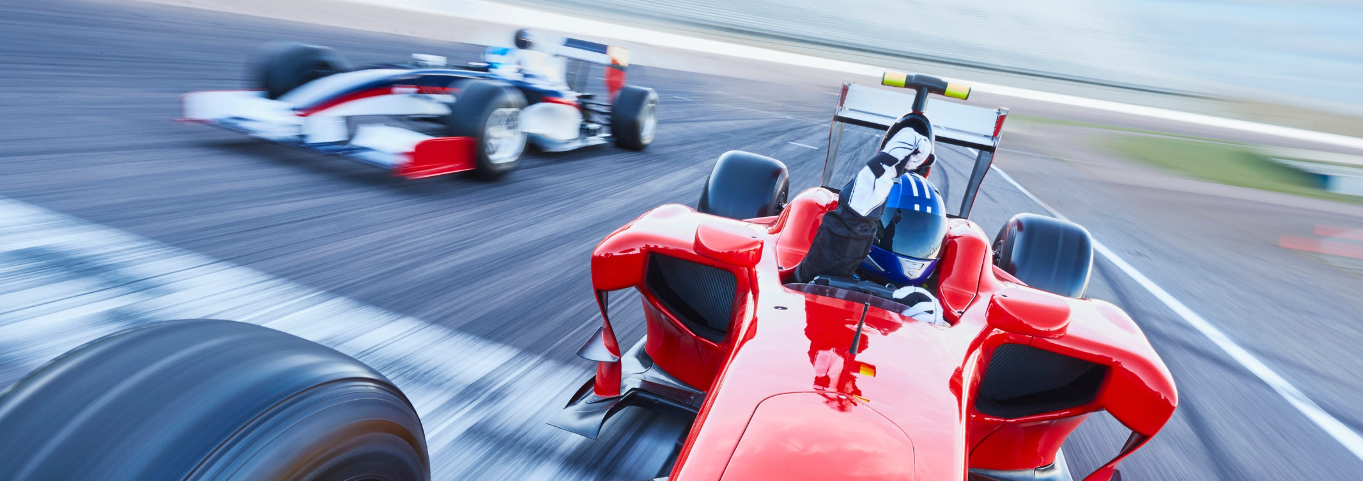 Racecars racing on racetrack