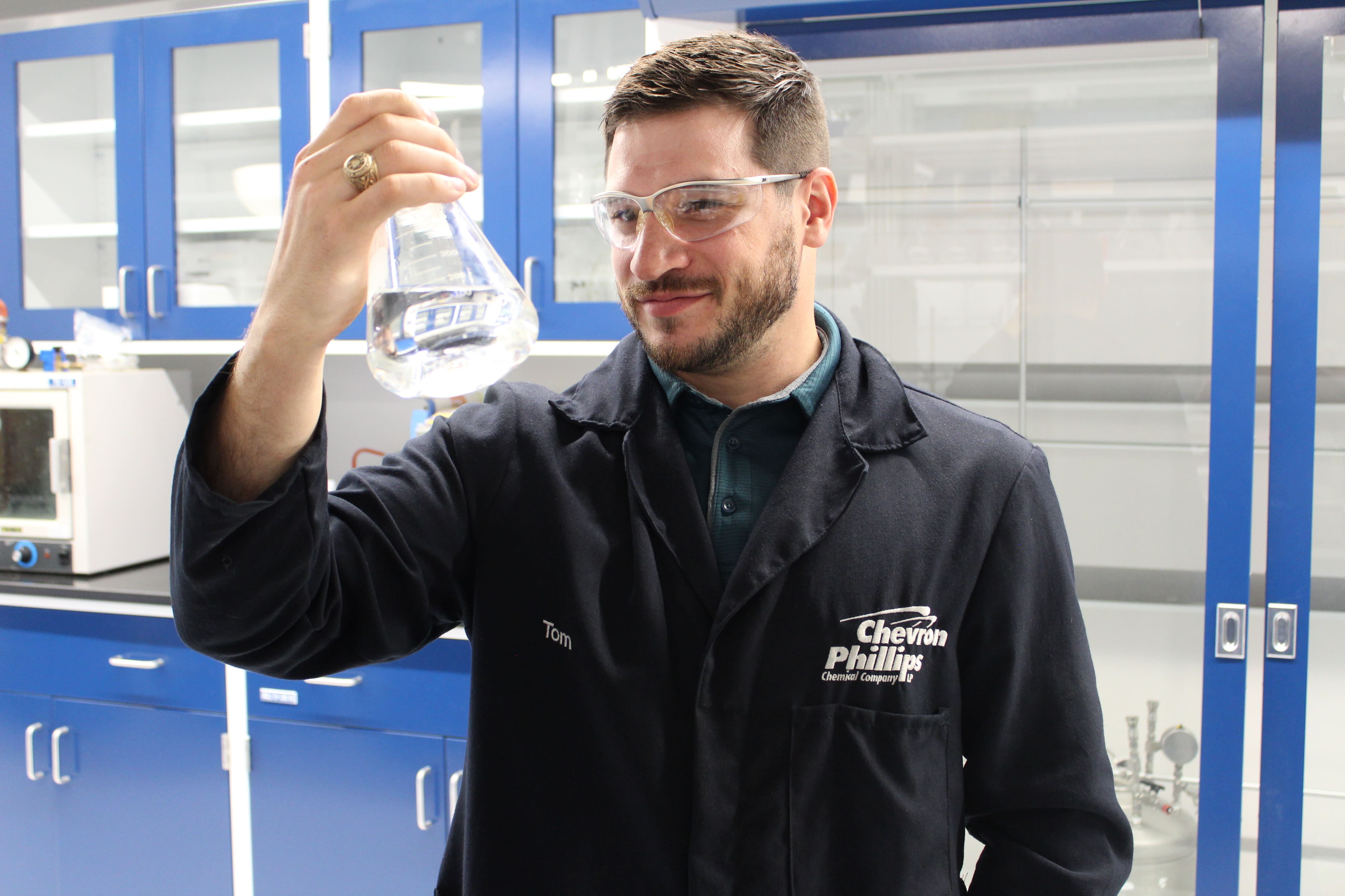 tom holding a beaker with clear liquid
