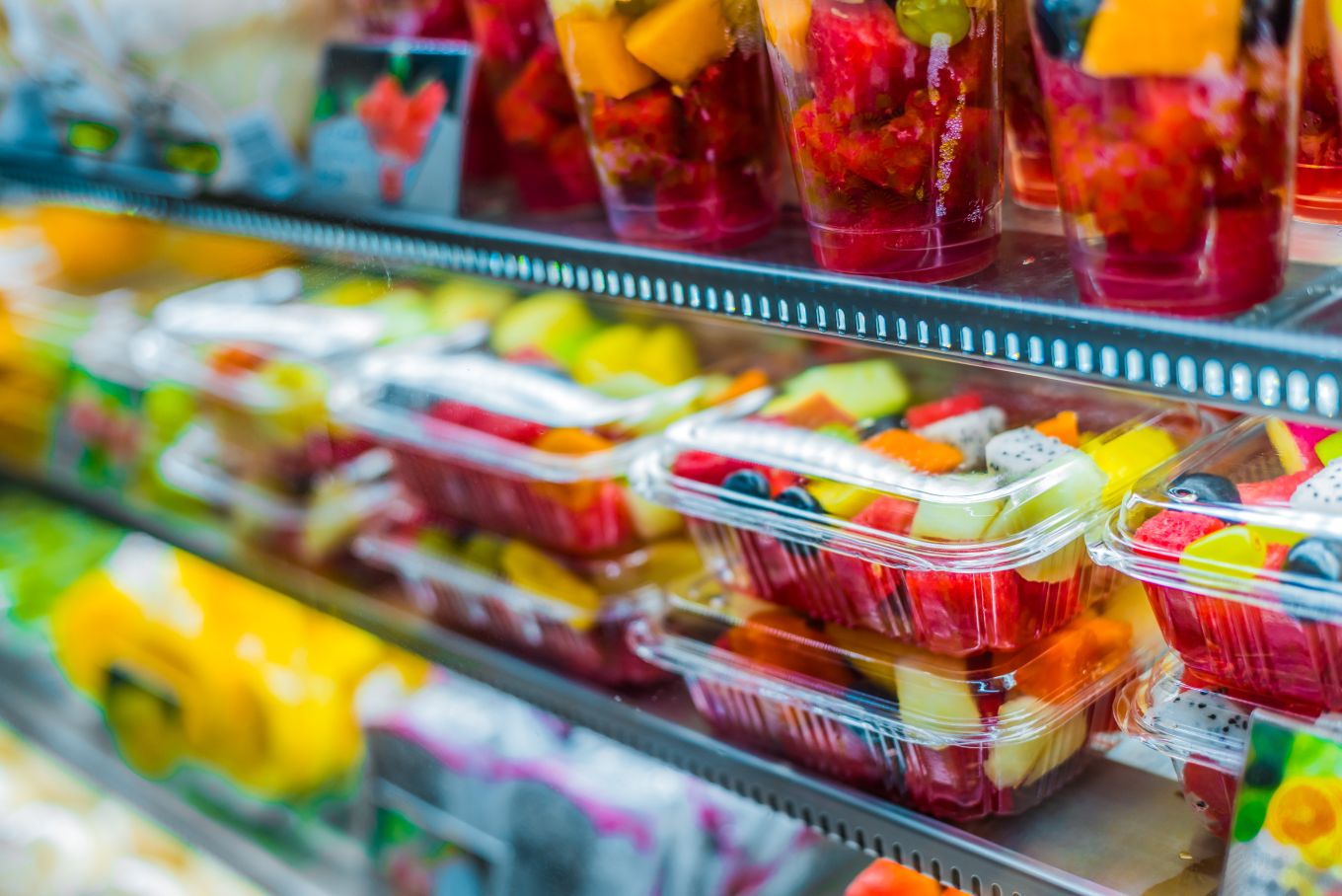 Plastic food containers holding cut fruits