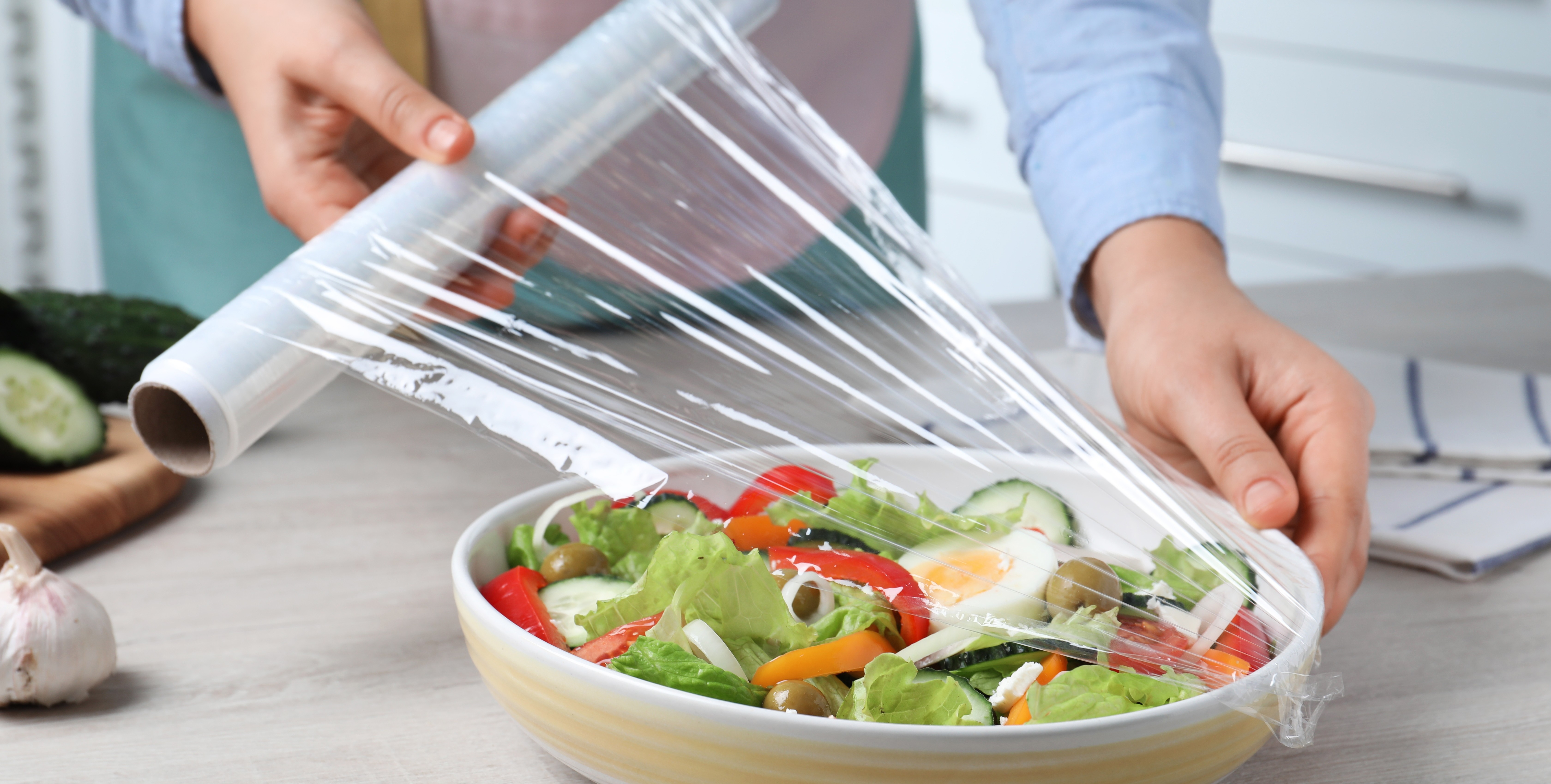Plastic Wrap placed over salad in bowl